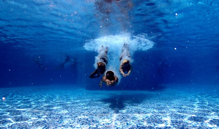 Underwater photo of three people diving