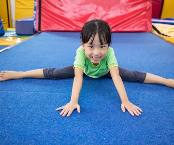 Little girl practicing gymnastics in a gymnastics center