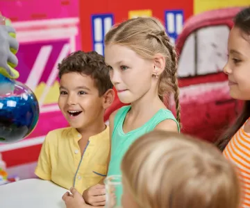 Science show for kids. Colorful liquid with steam and smoke