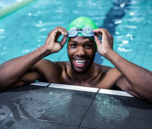 Smiling fit african american man in the swimming pool