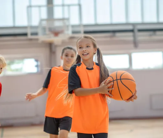 Kids in bright sportswear having basketball game