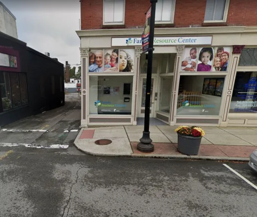 Street view of the Taunton Family Resource Center building with white sign above anddecal windows
